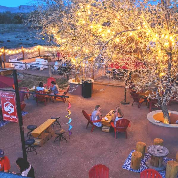 People sitting around fires at Highland's Distillery